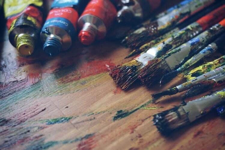 three-paint-tubes-near-paint-brushes-5101468